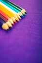 Nine multicolored pencils on a purple felt background. Different colored pencils with space for text. Back to school. Art lessons Royalty Free Stock Photo