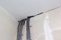 Nine polyethylene pipe goes between wall and the ceiling