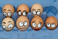 Nine sad frightened egg faces in blue panel