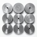 Nine Spiral Metal Rolls Arranged in Square Pattern on White Background Royalty Free Stock Photo