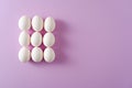 Nine white eggs on purple background, abstract easter concept