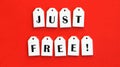 Nine white wooden tags with the word JUST FREE on a red background Royalty Free Stock Photo