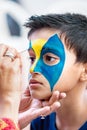 Nine year boy child young having his face painted for fun at a birthday party Royalty Free Stock Photo