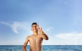 A nine-year-old boy is depicted at the beach, completely soaked. Royalty Free Stock Photo