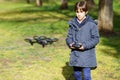 Nine-year-old girl operating toy drone flying by remote control Royalty Free Stock Photo