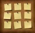 Nine yellow notes pinned to grunge cork background Royalty Free Stock Photo