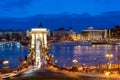 Nineteenth century Chain Bridge Szechenyi Lanchid and Budapest cityscape at night. Budapest, Hungary