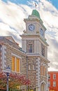 nineteenth century clock tower with roman numerals and weathervane in Fall