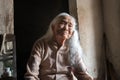 Ninh Binh, Vietnam - Apr 10, 2017: Portrait of an elderly woman with white hair living alone in the very old and poor house.