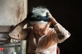 Ninh Binh, Vietnam - Apr 10, 2017: Portrait of an elderly woman with white hair living alone in the very old and poor house.