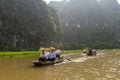 Boats of tourists on the Ngo River at Trang An UNESCO World