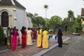 Ninh Binh, Vietnam - May 16, 2015: Vietnamese Christian women wearing traditional dress Ao Dai perform ritual at local church