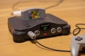 A Nintendo 64 Console Turned On With Super Mario 64 in the Cartridge Slot Royalty Free Stock Photo