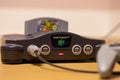 A Nintendo 64 Console Turned On With Super Mario 64 in the Cartridge Slot Royalty Free Stock Photo