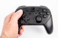 Nintendo Pro Controller for Nintendo Switch in hand of man, black console for gamers on white