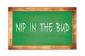 NIP IN THE BUD text written on green school board