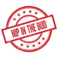 NIP IN THE BUD text written on red vintage round stamp