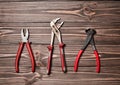 Nippers, wrench, pliers on a wooden table