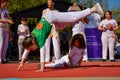 Dynamic Capoeira Showcase: Gravity-Defying Acrobatics on the Open Stage Royalty Free Stock Photo