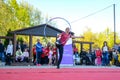 Graceful Gymnast: Young Girl Twirling Hoop Around Leg on Open Stage for International Dance Day Celebration