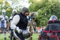 Intense Knight Encounter: Helmeted Warrior Engaging in Conversation with Axe-Wielding Knight Royalty Free Stock Photo