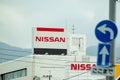 Nissan logo sign on a building of Nissan car dealer.