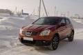 Nissan Qashqai in red color. This is crossover that combines modark design and compact hatchback refinement with functionality