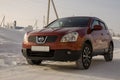 Nissan Qashqai in red color. This is crossover that combines modark design and compact hatchback refinement with functionality