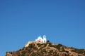 Nisyros island church with montain sky and sun