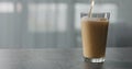 Nitro light ale beer pouring into pint glass on terrazzo countertop with window on background Royalty Free Stock Photo