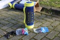 nitrous oxide or laughing gas cylinder for recreational drug usage left on street with balloons