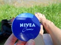 Nivea cream in hand female outdoor