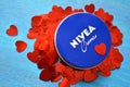 Nivea cream product and red hearts blue background Royalty Free Stock Photo