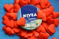 Nivea cream product and red hearts blue background Royalty Free Stock Photo