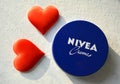 Nivea cream product and two red hearts white background Royalty Free Stock Photo