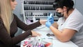 Nizhnevartovsk, Russia - August 12, 2019: Hardware manicure. manicurist makes hardware manicure for woman in beauty