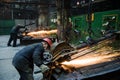 NIZHNY NOVGOROD, RUSSIA - OCT 7, 2017: Industrial workers with work tool. Big chainsaw in hands at steel factory. Royalty Free Stock Photo