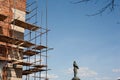 Nizhny Novgorod, Russia, 04.15.2021, restoration of an old red brick wall. scaffolding of wooden planks encircled the ancient defe