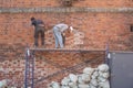 Nizhny Novgorod, Russia, 04.15.2021, restoration of an old red brick wall. scaffolding of wooden planks encircled the ancient defe