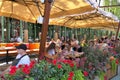 Nizhny Novgorod, Russia. switzerland park, 08.06.2022. People are sitting on the veranda of a summer cafe in the park