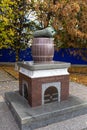Nizhyn, Ukraine - October 17, 2021: Monument to Nizhyn Cucumber. Giant pickle of green italian granite on top of brown barrel
