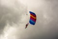 NIZHYN, UKRAINE - SEPTEMBER 17, 2016: Single skydiver On Colorful Parachute under cloudy rainy sky