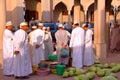 Omani men traditionally dressed gathering at a local vegetable market inside Nizwa Old Town