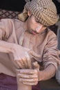 Potter making a piece of clay into a pottery piece