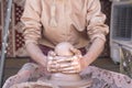 Potter making a piece of clay into a pottery piece