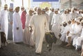 Man selling his goat at a market in Nizwa