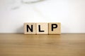 NLP neuro linguistic programming abbreviation from wooden blocks