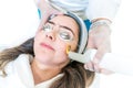 A 532 and 1064 nm wavelength and Nd:YAG laser being used as a skin treatment on female patient, in a beauty clinic. Shows hand Royalty Free Stock Photo