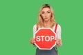 No access, prohibited to go! Portrait of serious bossy adult woman holding octagonal red Stop traffic sign