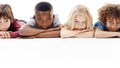 No adults allowed. Studio shot of a group of young friends lying on the floor together against a white background. Royalty Free Stock Photo